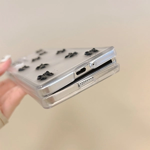 Close-up of precise cutouts and black bow details on a clear folding phone case