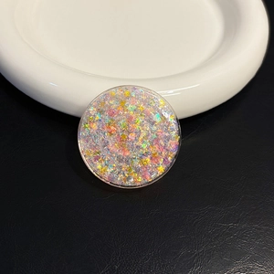 Macro shot of the round holographic glitter phone socket with star and heart sequins