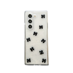 Clear Samsung Z Flip 6 case with silver glitter and 3D black bow tie decorations