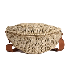 Handwoven straw waist bag with adjustable brown strap and crescent shape for summer beach wear