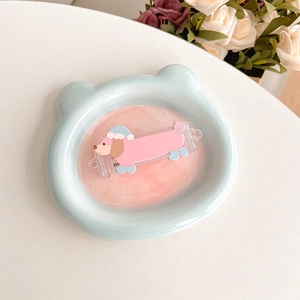 Detail of pink cartoon dachshund acrylic clip on blue bear plate with floral background