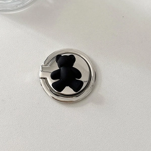 Detail of metal phone ring holder featuring a cute black bear on a silver base