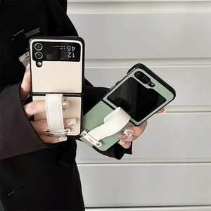 Elegant leather case for Z Flip 6 with wrist strap and textured finish on neutral background
