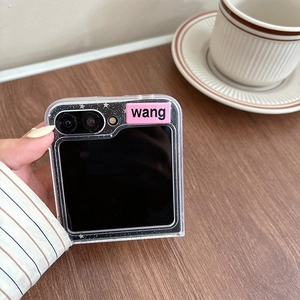 Close-up of pink decorative plaque and silver glitter on transparent foldable phone case