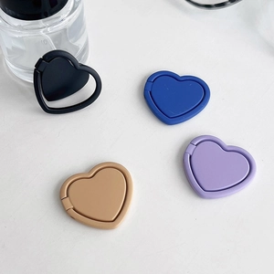 Detail view of heart-shaped phone ring holders in four different matte solid colors
