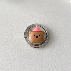 Detail of cute resin bear phone ring holder with metal base on white background