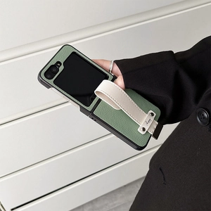 Detail view of sage green leather folding case with happy strap for Samsung Galaxy Z Flip