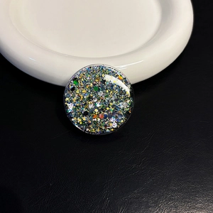 Macro shot of circular heart-shaped grip tok with colorful glitter and sequins