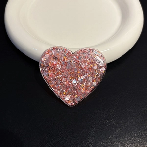 Macro shot of pink glitter heart resin socket for mobile phone grip and stand