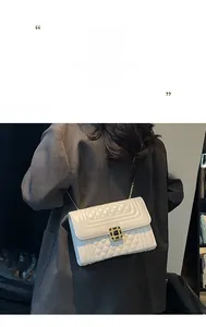 Detailed close-up of cream quilted crossbody bag with gold chain and luxury square clasp