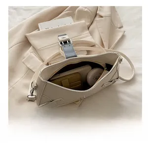 Detailed capacity view of the beige crocodile pattern saddle bag showing internal storage