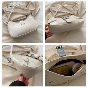 Detail view of white croc-embossed underarm bag showing interior capacity and texture