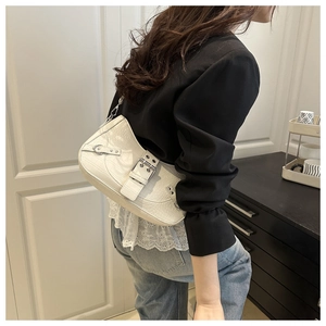 White baguette bag with crocodile texture and metal buckles shown in side view