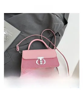 Detailed macro view of pink square bag featuring silver metallic lock and fabric texture