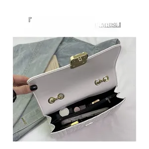 Detail of the white quilted shoulder bag interior showing organized storage compartments