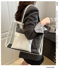 Detail view of transparent PVC tote bag with white rope handles and inner pouch