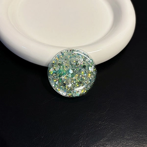 Detailed macro view of heart-shaped glitter flakes in clear resin phone grip accessory