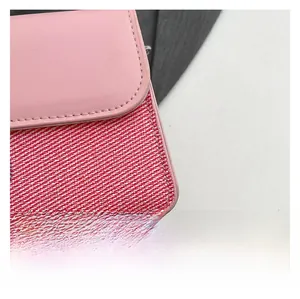 Macro view of pink leather flap and red-white twill fabric texture with stitching