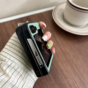 Chic leather wristband case for Samsung Z Flip6 held by a woman in a cafe setting