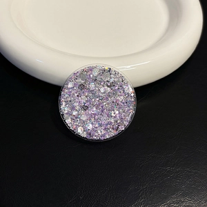 Detailed view of round phone socket with purple and silver glitter sequins in resin