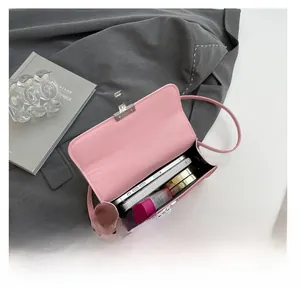 Pink crossbody bag interior showing storage capacity for phone and cosmetics