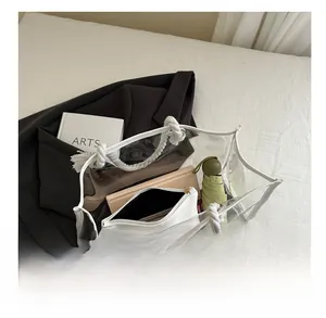 Detail view of transparent PVC tote bag capacity showing internal storage and cotton rope handles