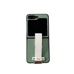 Sage green leather case for Samsung Galaxy Z Flip with a cream wristband strap and happy text