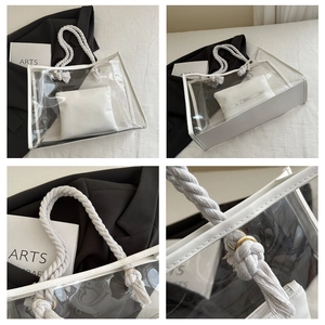 Detail view of transparent PVC tote bag with white trim and cotton rope handles
