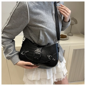 Detail of black crocodile pattern hobo bag with metal buckle and adjustable shoulder strap