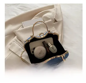 Internal view of denim blue handbag showing capacity for phone and cosmetics