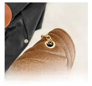 Detail of brown corduroy bag showing gold metal ring and premium chain strap