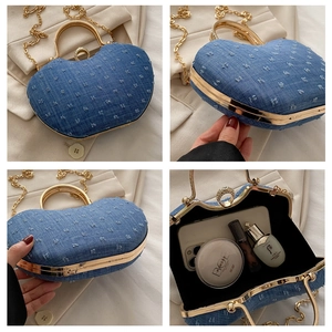 Detail view of heart-shaped blue denim evening bag with crystal ring clasp and gold chain
