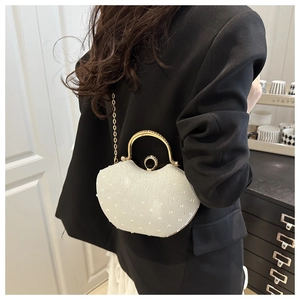 Elegant white shell evening bag with rhinestone ring handle and gold chain detail