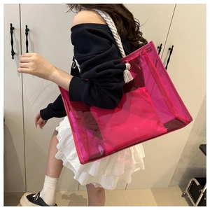 Detail view of pink transparent tote bag with cotton rope handles and matching inner pouch