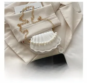 Mini pearl chain shell bag in creamy white with smartphone for size comparison