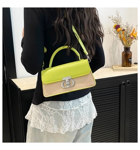 Model wearing a two-tone contrast bag with lime green leather and woven fabric details