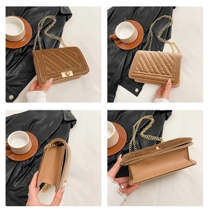 Detail view of brown velvet crossbody bag with V-quilted texture and gold chain strap