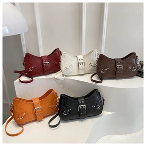 Five crocodile-embossed faux leather shoulder bags with large metal buckles in various colors