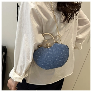 Detail of denim blue rhinestone clutch with golden ring handle and chain strap for women