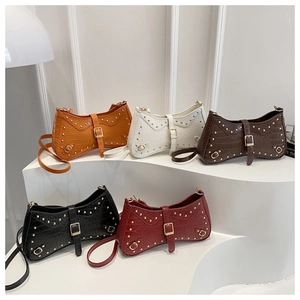 Detailed row of mini baguette bags with crocodile texture and punk rivets in five colors
