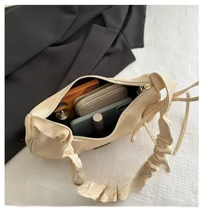 Spacious interior of beige woven handbag showing phone, wallet and cosmetics capacity