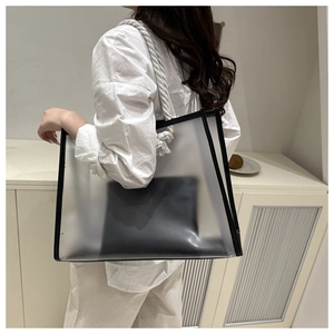 Translucent PVC tote bag featuring black trim and white cotton rope handles on a model