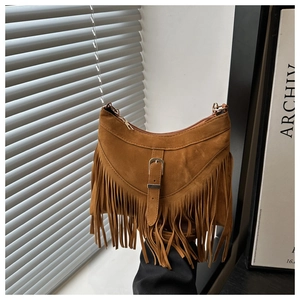 Close-up of brown suede shoulder bag with long fringes and gold buckle detail