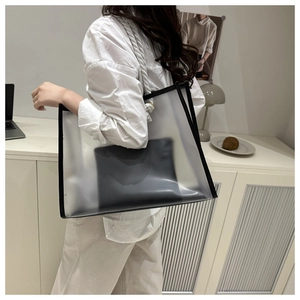 Detailed shot of large transparent tote bag with matte finish and black trim detail