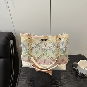 Canvas denim tote bag with colorful stars, frayed edges, and golden chain straps