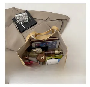 Top view showing large interior capacity of beige leather tote bag for daily essentials