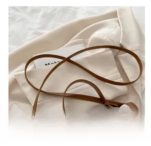 Détail du sac en cuir matelassé blanc avec motifs de losanges et sangle brune
