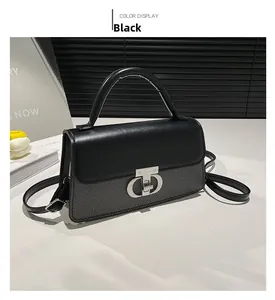 Detail view of the black textured PU leather handbag with silver twist lock and handle