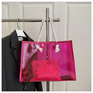 Detailed view of pink transparent PVC tote bag with thick rope handles and inner pouch