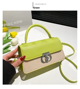 Detail of green leather bag with woven texture, silver CD buckle, and floral decor